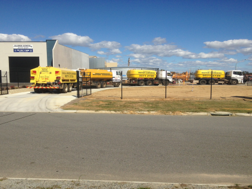 Water truck convoy being filled up